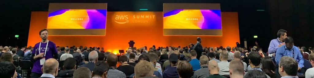 |Welcome to the AWS Summit|AWS Summit|Crowd watching the AWS Summit talk|AWS Summit London Logo|Arif with the AWS Mascot at the AWS Summit