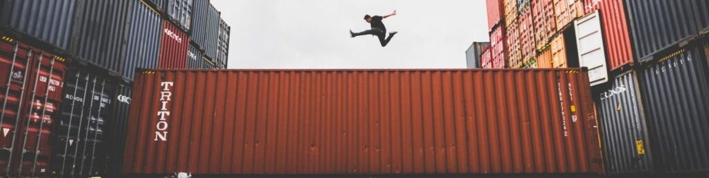A man jumping on a container|A man jumps over a container|Cubes|Droids|A happy woman by a computer|Cut up pages|A graph showing an upward trend|A music conductor|a diagram