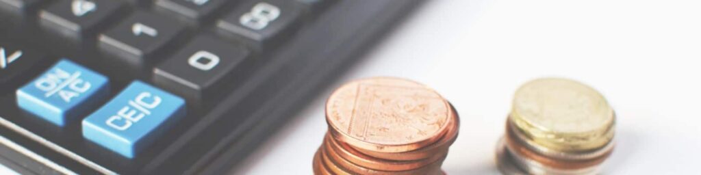 Coins and a piggy bank|coins and a calculator|a yes or no check box on paper with a person holding a pen|A calculator and some money