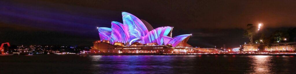Juan with Kris and Milly|SUGCON ANZ event|The JAM ANZ Team|Sydney opera house lit up with blue and purple lights for Sydney Light Festival