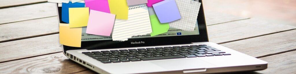 A laptop with post its on it|A laptop with post it notes on it|A laptop with a post it notes on it|A man in black and white||Umbraco's logo